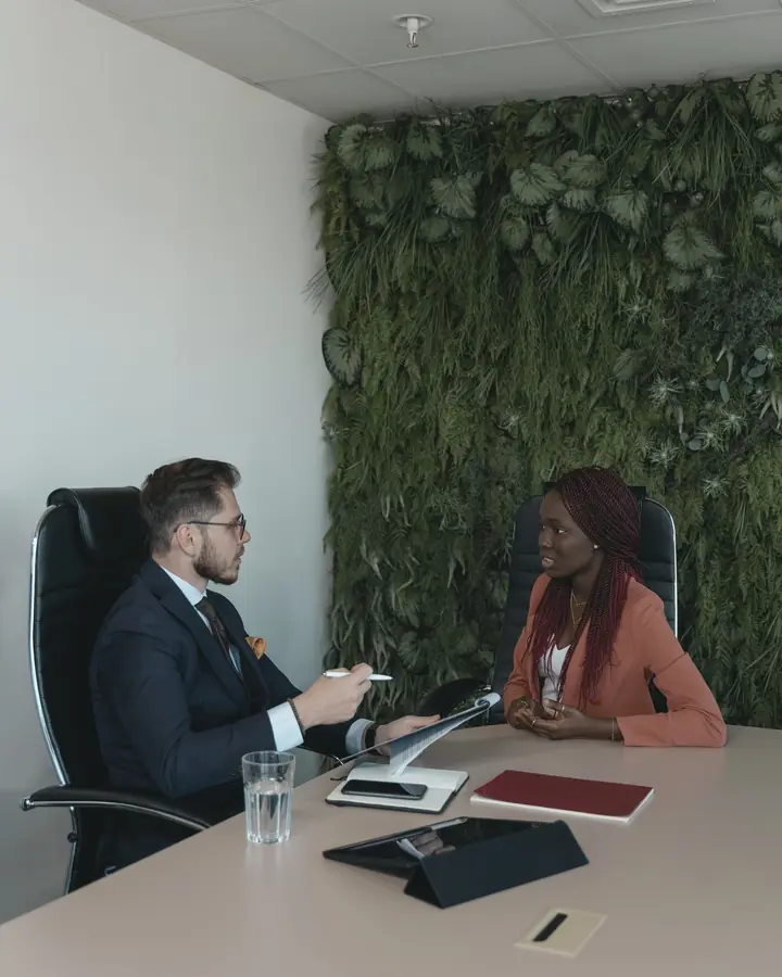 A LabourLink consultant and an employee talk across a boardroom table