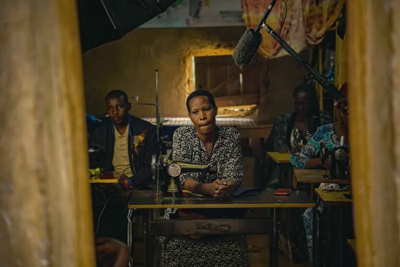 Tailors at work in a busy clothing workshop